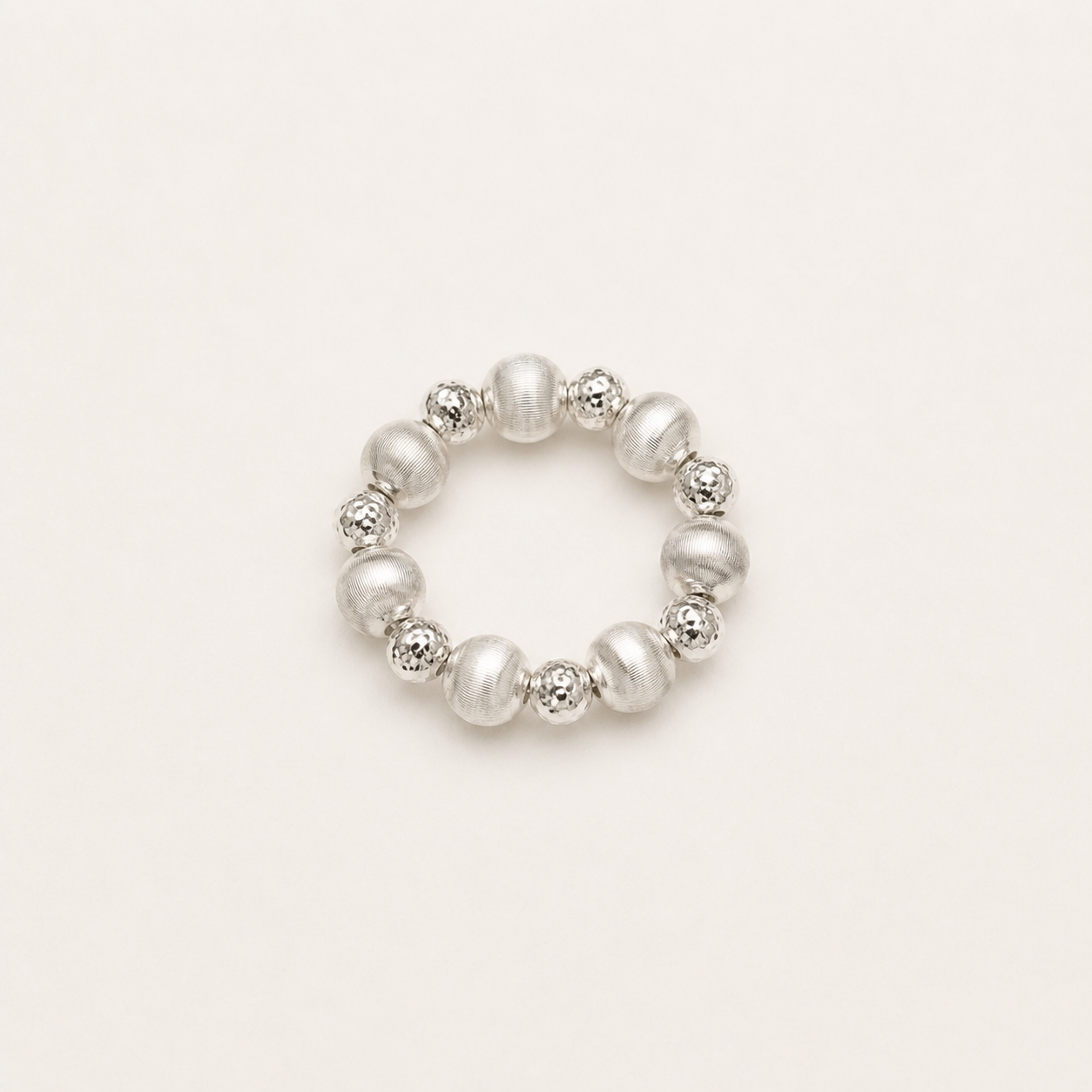 Gemina sterling silver elastic ring with alternating brushed and diamond-cut beads