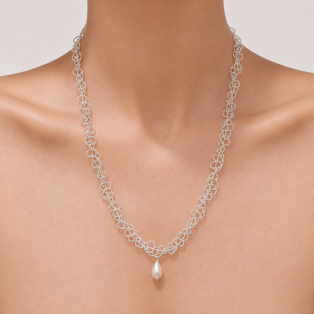 Gemina Camille silver lace chain necklace with a teardrop pearl, worn doubled at the collarbone