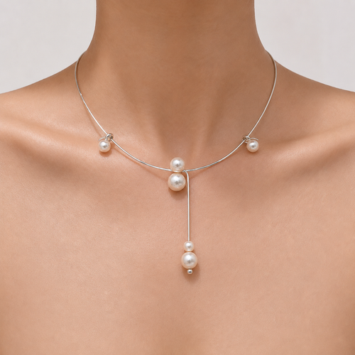 Gemina Colette rigid silver collar necklace with freely sliding pearls, worn at the collarbone