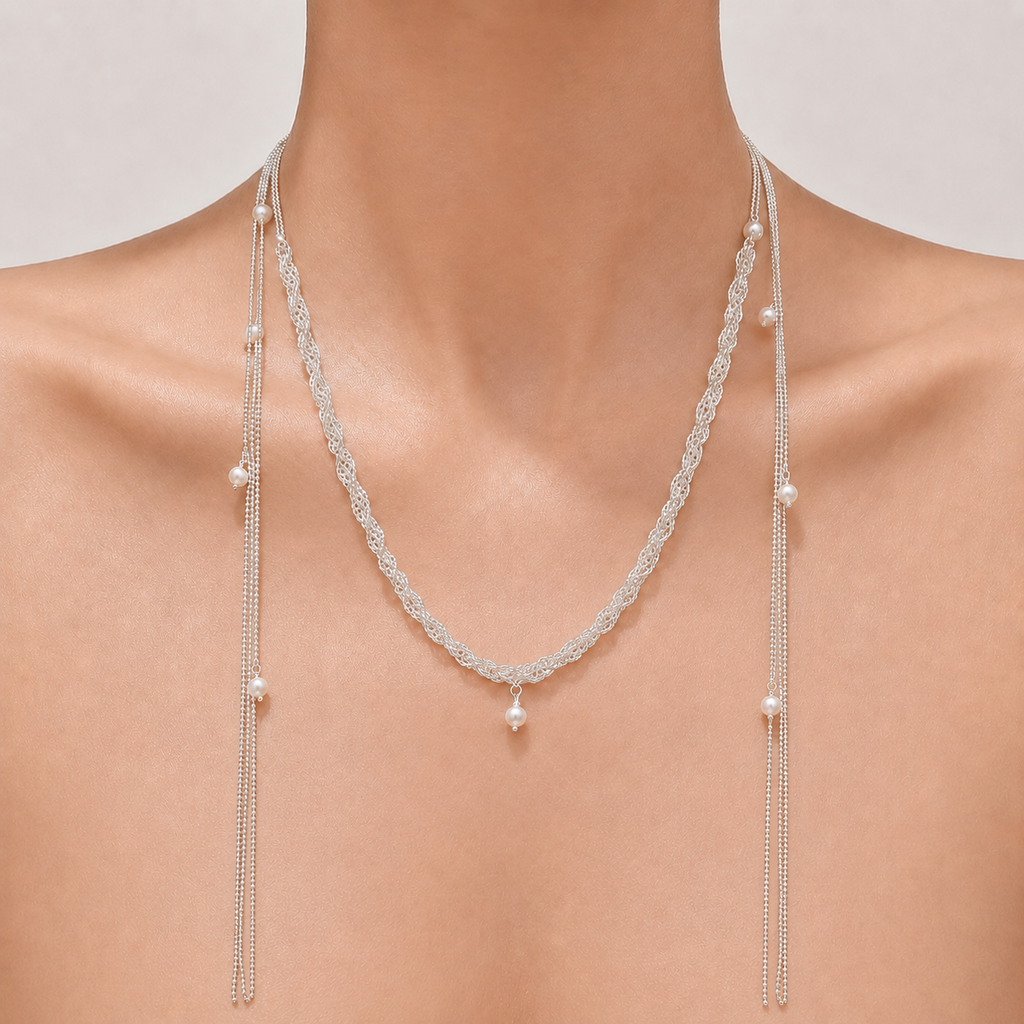 Gemina Delphine braided silver necklace with scattered pearls and long tassel ends, worn draped
