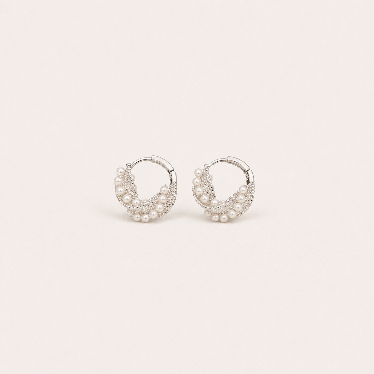 Gemina Manon silver huggie hoop earrings set with a beaded pearl wreath